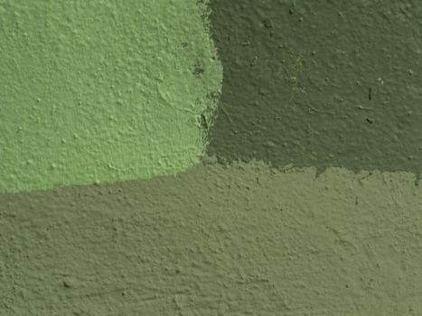 Fragment of a wall painted with three-tone paint. Fragment of a wall with old shabby plaster.