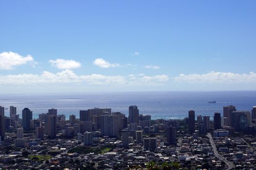Honolulu Townscape, roads, buildings, skyscrapers, parks,  and Pacific Ocean with boats in the water on Oahu, Hawaii.