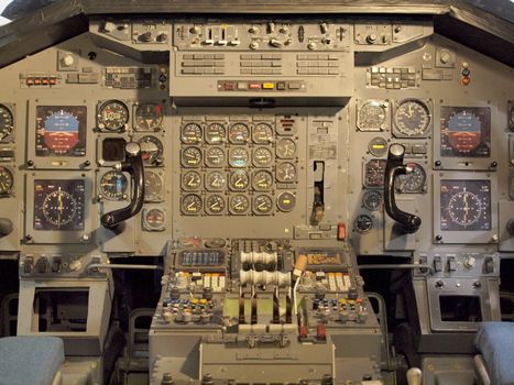 Jet aircraft cockpit Equipment with various indicators, buttons, and instruments.