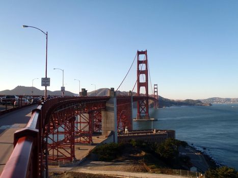 The Golden Gate Bridge in San Francisco bay seen from beginning of bridge on San Frnacisco side in California.  Old historic Fort Point can be seen below bridge.