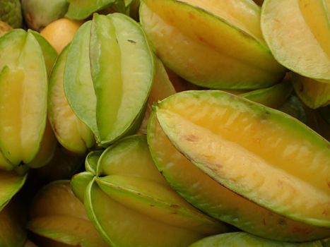 pile of Starfruit on sell at farmers market in Maui