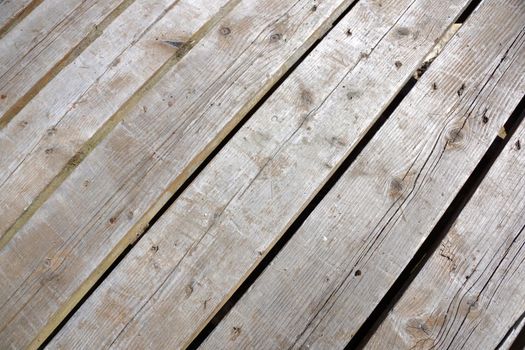 wood plank walkway with small cracks at a slanted angle.