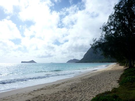 Gentle wave lap on Waimanalo Beach looking towards Rabbit island and Rock island on a nice day Oahu, Hawaii.