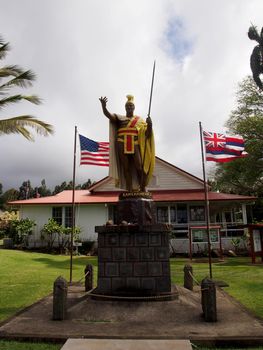 King Kamehameha Statue in historic town Kapaau.  The statue is in front of the North Kohala Civic Center stands the original King Kamehameha I Statue, erected not far from where Hawaii’s greatest king was born.  A great warrior, diplomat and leader, King Kamehameha I united the Hawaiian Islands into one royal kingdom in 1810 after years of conflict.  Forged in Florence, Italy in 1880, the ship that was ferrying it to Honolulu sank off the Falkland Islands. Believed to have been lost at sea, a replacement statue was commissioned and was erected in Downtown Honolulu and has become one of the most photographed landmarks on Oahu. However, the original statue was miraculously found and recovered in 1912. The restored statue was then installed near Kamehameha’s birthplace at Kapaau.