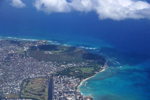 Aerial view of Diamondhead, Kapiolani Park, Waikiki, Ala Wai Canal, Kapahulu town, Pacific ocean, clouds, and Golf Course on Oahu, Hawaii.