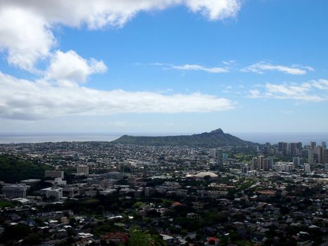 Diamondhead and the city of Honolulu on Oahu on a nice day with a few clouds in the sky. UH Manoa, Waikiki, Kahala and the H-1 Visible, seen from Round Top Dr. lookout point.
