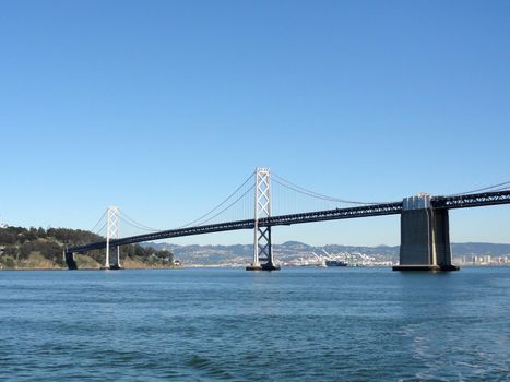 San Francisco Bay Bridge and Bay as Bridge enters into Yerba Buena island with Oakland in the distance of a clear day. February 2011