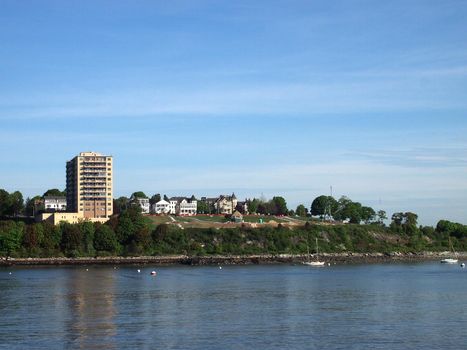 Historic Fort Allen Park and surrounding homes and buildings in Portland, Maine seen from the water.