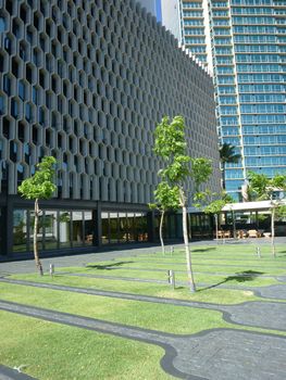 HONOLULU, HI - JUNE 23, 2014:  Garden at Historic IBM Building after a $20 million makeover on Oahu, Hawaii.  at 1240 Ala Moana Blvd. was designed by the famed late architect Vladimir Ossipoff. The most distinctive feature of the building is its concrete grille, which was custom-made and put in place to act as a sunscreen. 