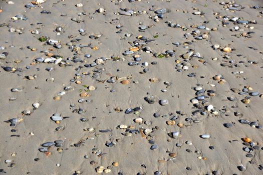 Pebble rocks in the sand.  Background, texture.