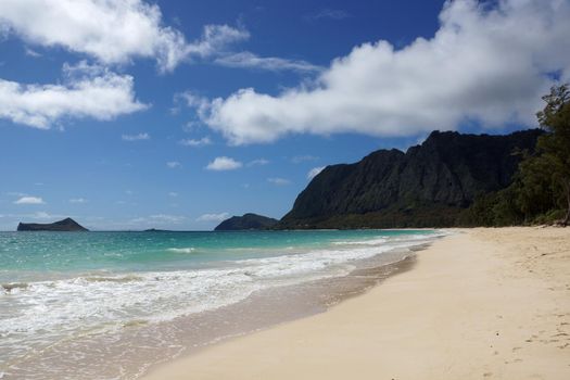 Gentle wave lap on Waimanalo Beach looking towards Rabbit island and Rock island on a nice day Oahu, Hawaii.  July 2014.