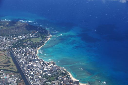 Aerial view of Diamondhead, Kapiolani Park, Waikiki, Ala Wai Canal, Kapahulu town, Pacific ocean, clouds, and Golf Course on Oahu, Hawaii.