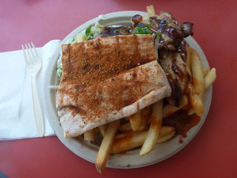 Mauka - Makai: BBQ Chicken AND Ono with coleslaw and french fries on a paper plate with plastic fork and knife.