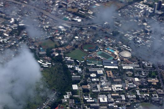 Aerial view of Landmark University of Hawaii Baseball Les Murakami Stadium, Stan Sheriff Center, and college campus in Manoa with H-1 Highway and Surrounding town community Honolulu, Hawaii June 13, 2014.