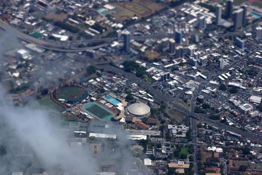 Aerial view of Landmark University of Hawaii Baseball Les Murakami Stadium and Stan Sheriff Center in Manoa with H-1 Highway and Surrounding town community Honolulu, Hawaii June 13, 2014.