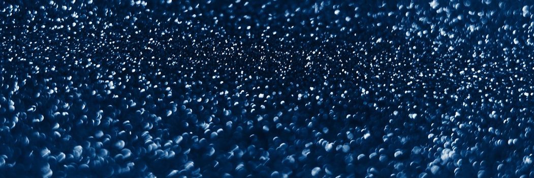 Glowing sparkles on blue color trendy background. Holiday bright brilliant beautiful background, template for blog or designers. Web banner. New Year .