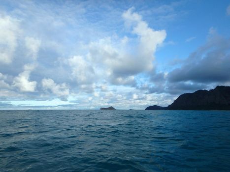 Gentle wave in Waimanalo Bay looking towards Rabbit island and Rock island at dusk on nice day Oahu, Hawaii.  September 2014.