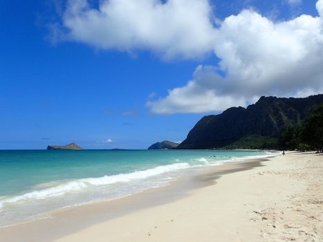 Gentle wave lap on Waimanalo Beach looking towards Rabbit island and Rock island on a nice day Oahu, Hawaii.  September 2014.