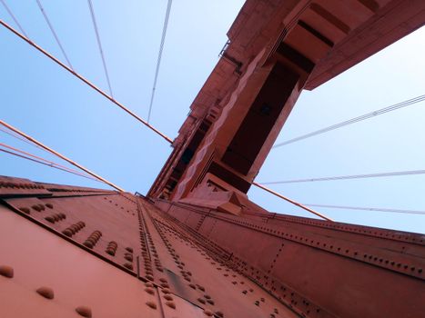 Upward perspective of Art Deco Tower and supporting cables on the Golden Gate Bridge.