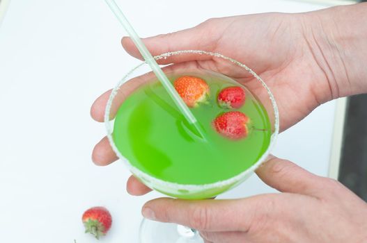 Colorful bright green cocktail cactus with strawberries, delicious refreshing summer drink, tonic drinks. High quality photo