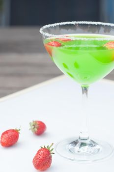 Colorful bright green cocktail cactus with strawberries, delicious refreshing summer drink, tonic drinks. High quality photo