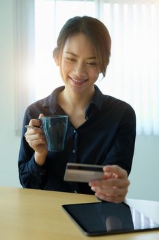 Online payment, Young Women's hands holding credit card and using tablet for online shopping