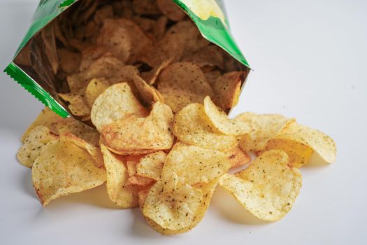 Potato chips in open bag, delicious BBQ seasoning spicy for crips, thin slice deep fried snack fast food in open bag.