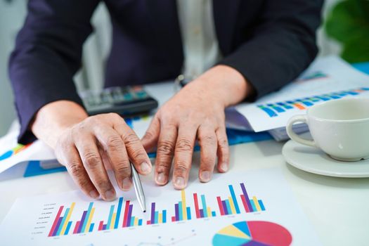 Businessman working and analysis with statistic graph in office.