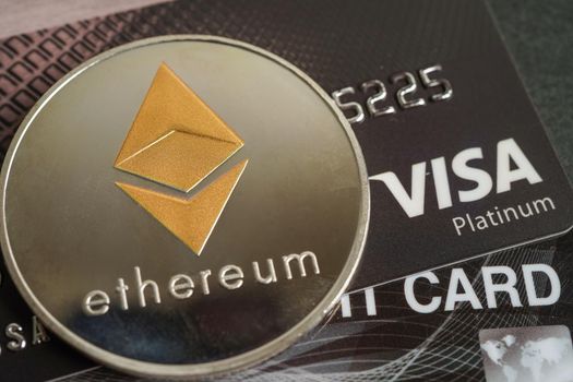 Bangkok, Thailand - December 15, 2021 Golden bitcoin with credit card on US dollar banknotes money for business and commercial, Digital currency, Virtual cryptocurrency.