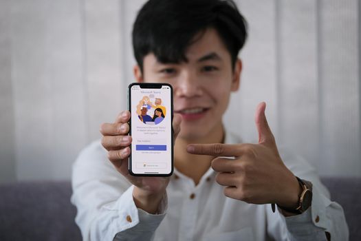 Chiangmai, Thailand - April 06, 2021: A user opens the Microsoft Teams mobile app. Teams is a unified team communication and collaboration platform with workplace chat, video meetings, and file storage..
