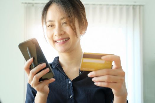 Online payment, Young Women's hands holding smprtphoene and credit card for online shopping.