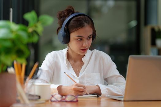 Image of Young woman working online on laptop computer. studying or working from home online concept