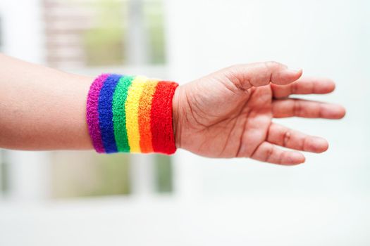 Asian woman with rainbow flag, LGBT symbol rights and gender equality, LGBT Pride Month in June.