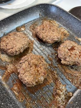 Hamburger cutlets are fried in a frying pan. High quality photo