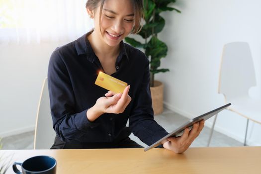 Online payment, Young Women's hands holding credit card and tablet for online shopping