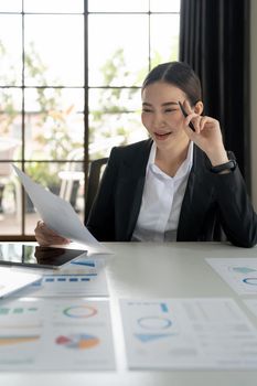 Business woman using calculator for do math finance on wooden desk in office and business working background, tax, accounting, statistics and analytic research concept.