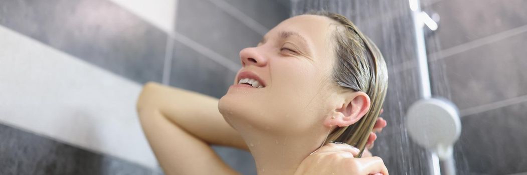 Portrait of happy woman take hot shower after hard day at work. Female topless enjoying healing water, release tension after stress. Hygiene, chill concept