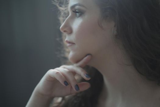 Portrait of a beautiful sensual young woman with curly hair