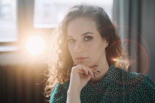 Portrait of a beautiful sensual young woman with curly hair