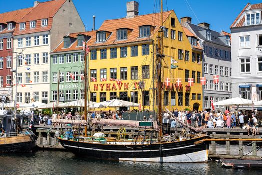 Copenhagen, Denmark - July 12, 2022: People enjoying a sunny summer day at Nyhavn Habor.
