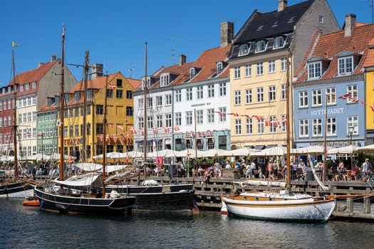 Copenhagen, Denmark - July 12, 2022: People enjoying a sunny summer day at Nyhavn Habor.
