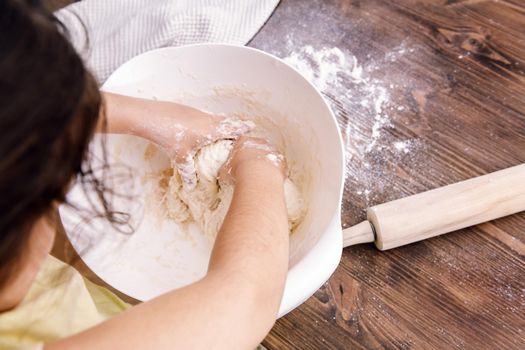 unrecognizable little girl making homemade bread dough, healthy food concept at home