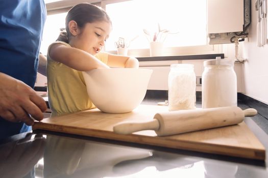 father and daughter preparing dough to make homemade bread, concept of healthy food at home