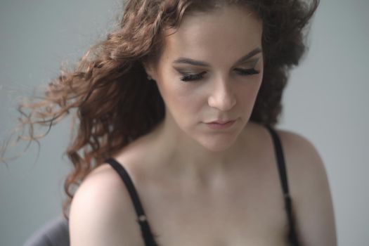 Portrait of a beautiful sensual young woman with curly hair