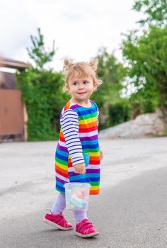 The child draws with chalk on the pavement. Selective focus. Kid.