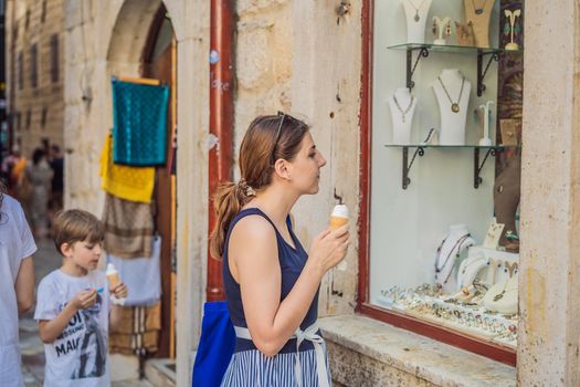 Woman tourist enjoying Colorful street in Old town of Kotor on a sunny day, Montenegro. Travel to Montenegro concept.