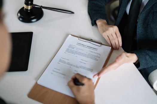 Lawyer Legal counsel presents to the client a signed contract with gavel and legal law. justice and lawyer Business partnership meeting concept