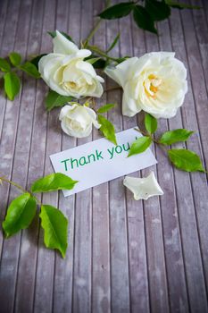 small bouquet of beautiful white summer roses, on a wooden table