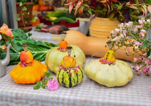 Small figures of women from pumpkins and zucchini and patissons