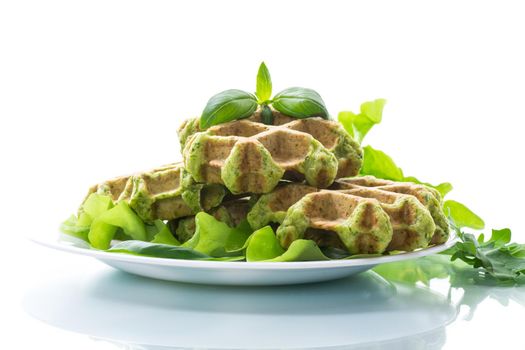 vegetable waffles cooked with herbs in a plate isolated on white background